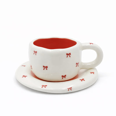 2939-23 ceramic cup and saucer set with coral ribbon bow design for tea and coffee serving – Siddiq Gifts Mussafah Abu Dhabi
