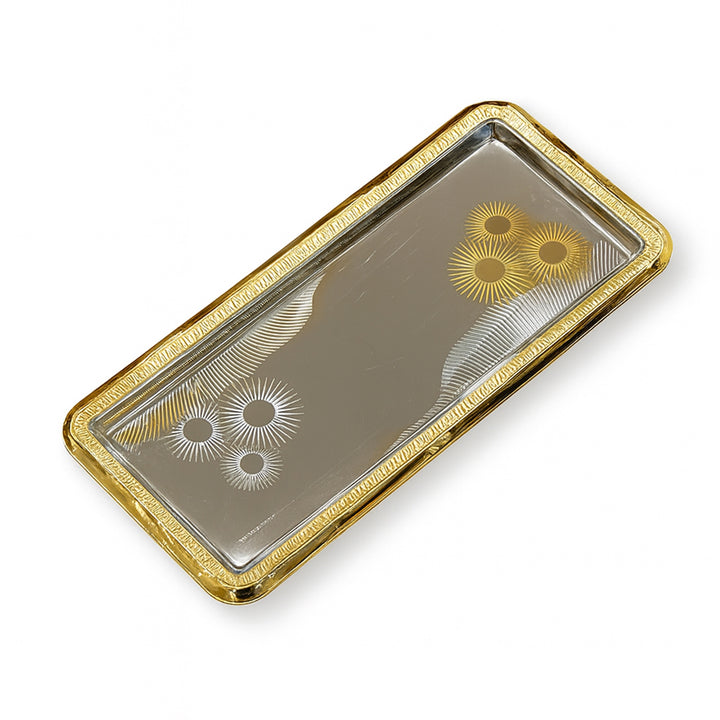 Decorative tray with gold rim and engraved patterns on a white background
