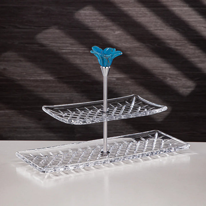 Two-tiered tray with a blue floral finial on a dark background