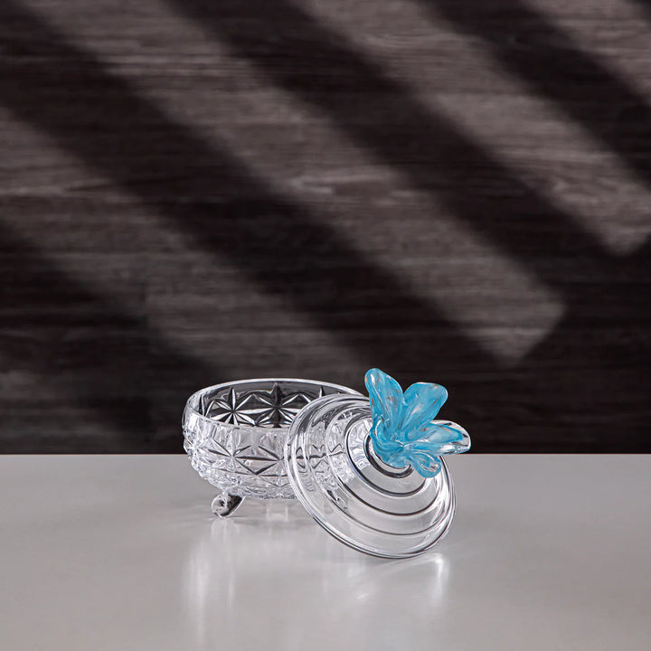 Clear glass bowl with a blue butterfly on a dark textured background