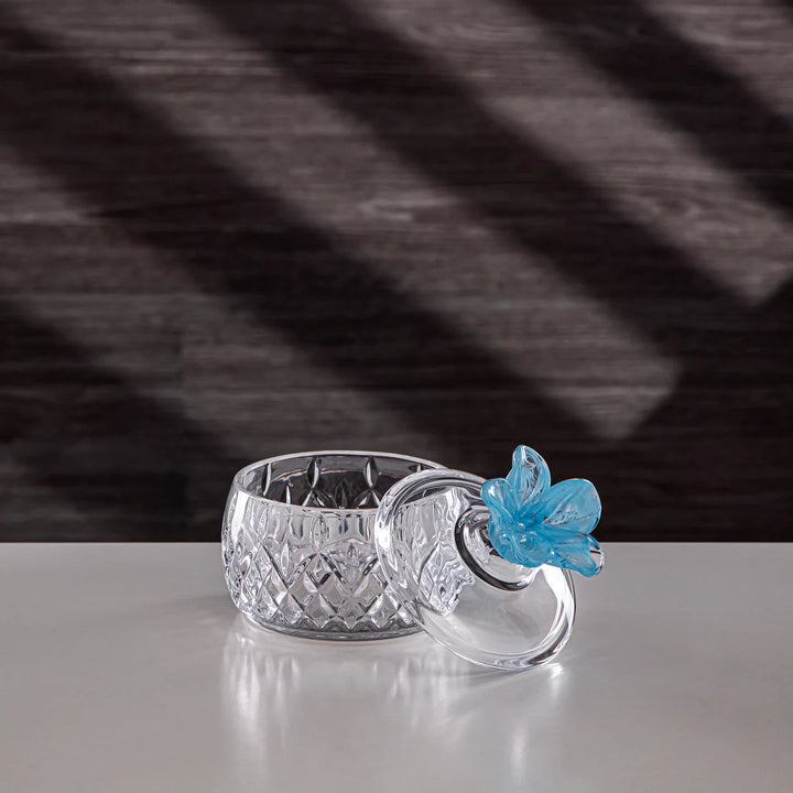 candle holder with a blue butterfly on a dark textured background
