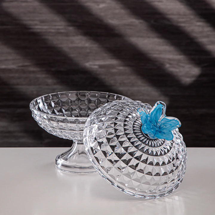 Clear glass candy dish with a blue butterfly on a dark background