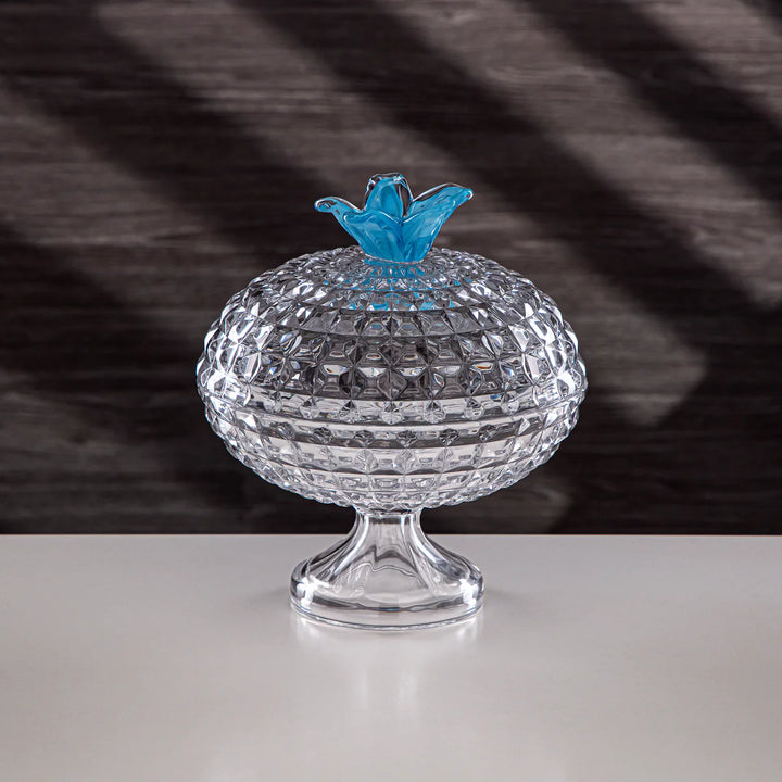 Clear crystal bowl with a blue butterfly on a dark striped background
