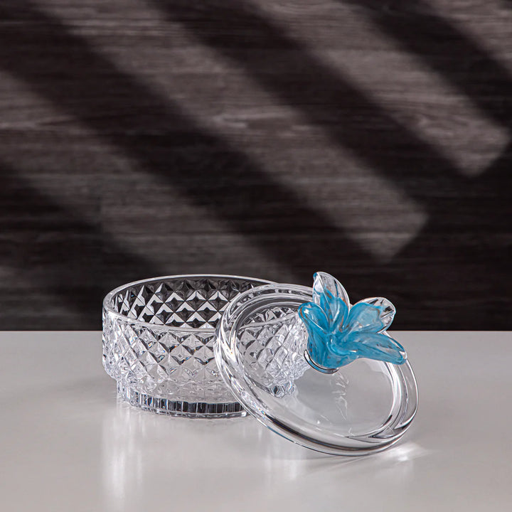 Crystal bowl with a blue butterfly on a gray surface
