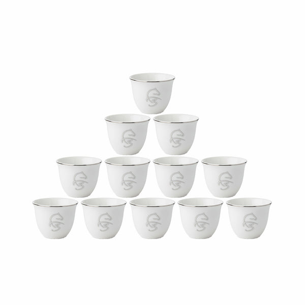 Set of twelve white ceramic cups with silver accents on a white background