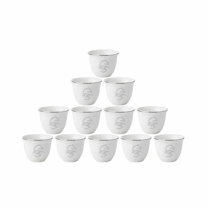 Set of twelve white ceramic cups with silver accents on a white background