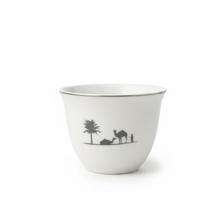 White ceramic cup with black illustrations of a palm tree, camel, and person on a white background