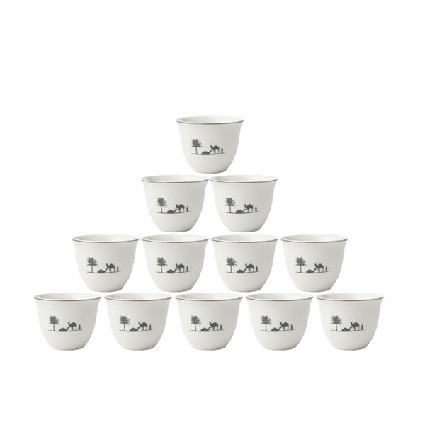 Set of white ceramic cups with black designs on a white background