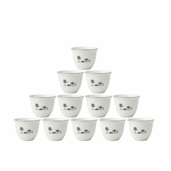 Set of white ceramic cups with black designs on a white background
