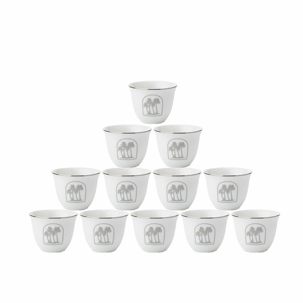 Set of twelve white ceramic cups with a decorative emblem on a white background