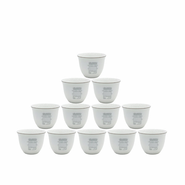 Set of twelve white ceramic cups with gray text on a white background