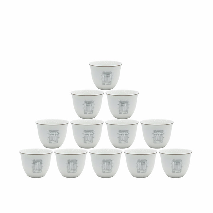 Set of twelve white ceramic cups with gray text on a white background