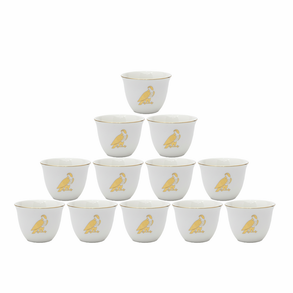 Set of 12 white cups with gold monkey design on a white background