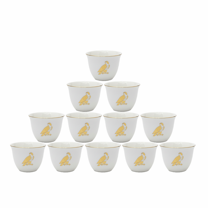Set of 12 white cups with gold monkey design on a white background
