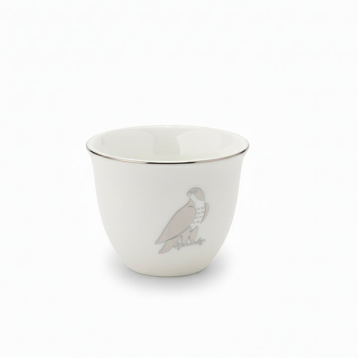 White ceramic cup with a bird design on a white background
