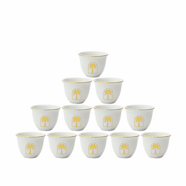 Set of 12 white cups with gold palm tree design on a white background