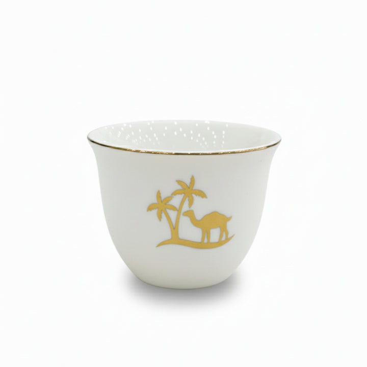 White ceramic cup with gold rim and camel design on a white background