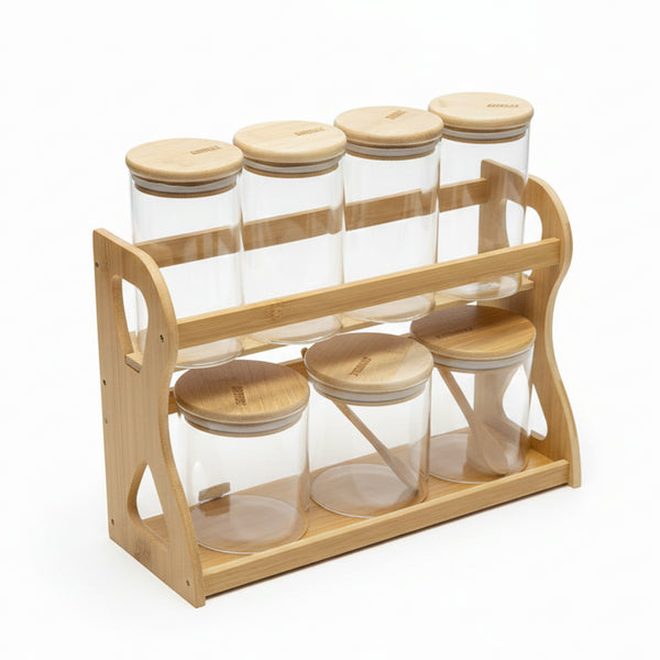 Wooden spice rack with glass jars and wooden lids on a white background