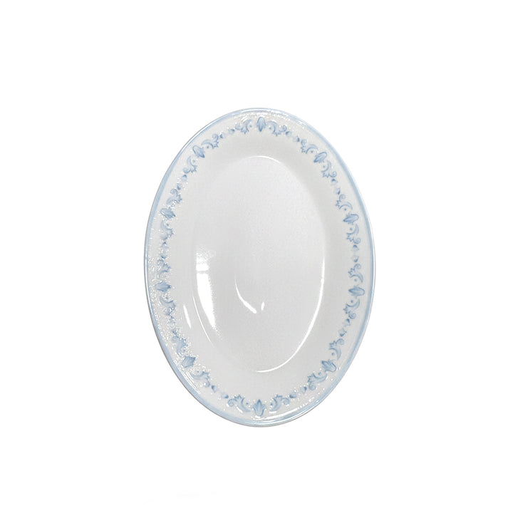 White oval plate with blue floral pattern on a white background