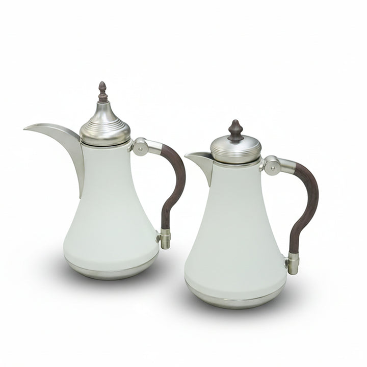Two white ceramic coffee pots with silver lids and handles on a white background