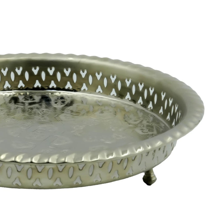 Decorative metal tray with intricate designs on a white background

