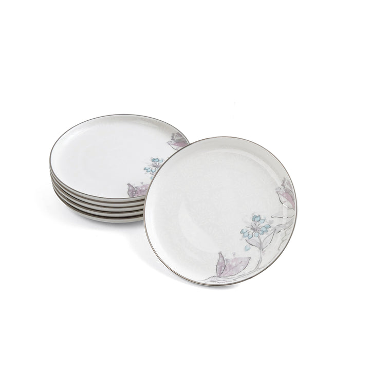 Set of ceramic plates with floral and butterfly design on a white background