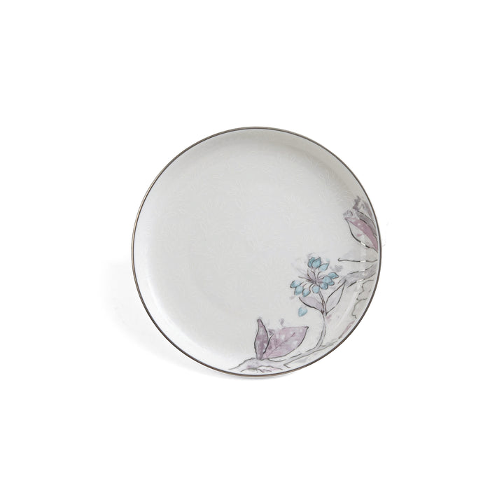 Decorative ceramic plate with floral and bird design on a white background