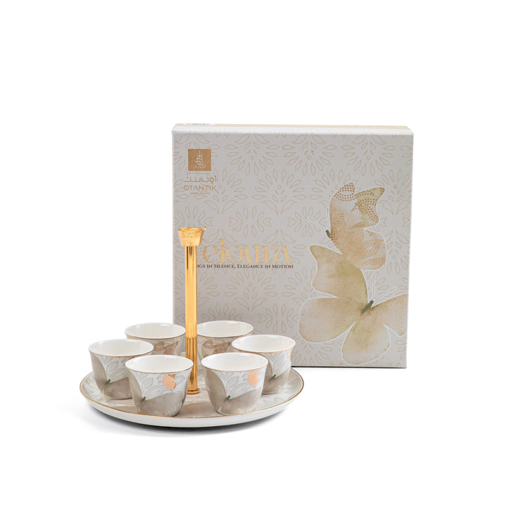 Set of ceramic cups with a decorative box on a white background