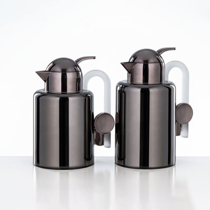 Two black and silver kitchen canisters on a white background