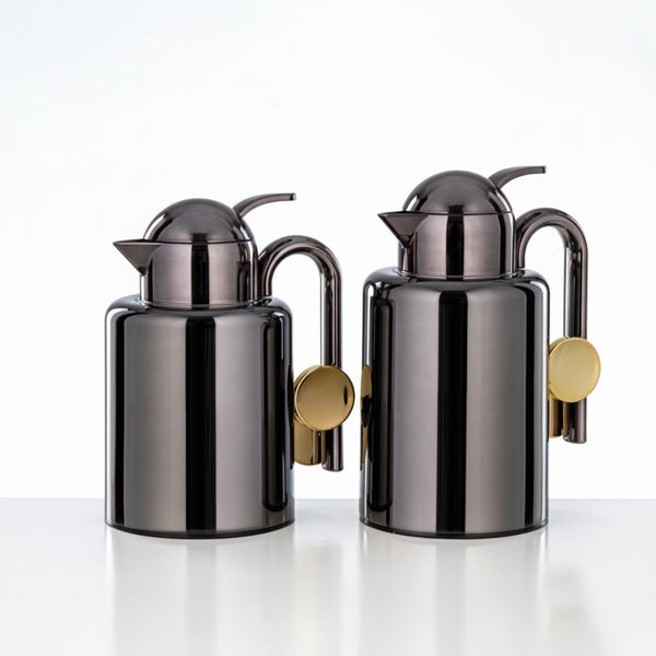 Two metallic oil dispensers with gold accents on a white background