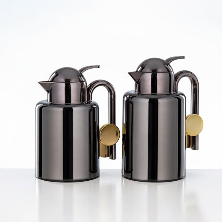 Two metallic oil dispensers with gold accents on a white background