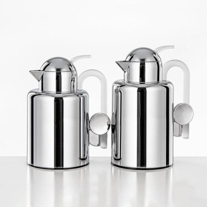Two chrome-plated milk jugs on a white background