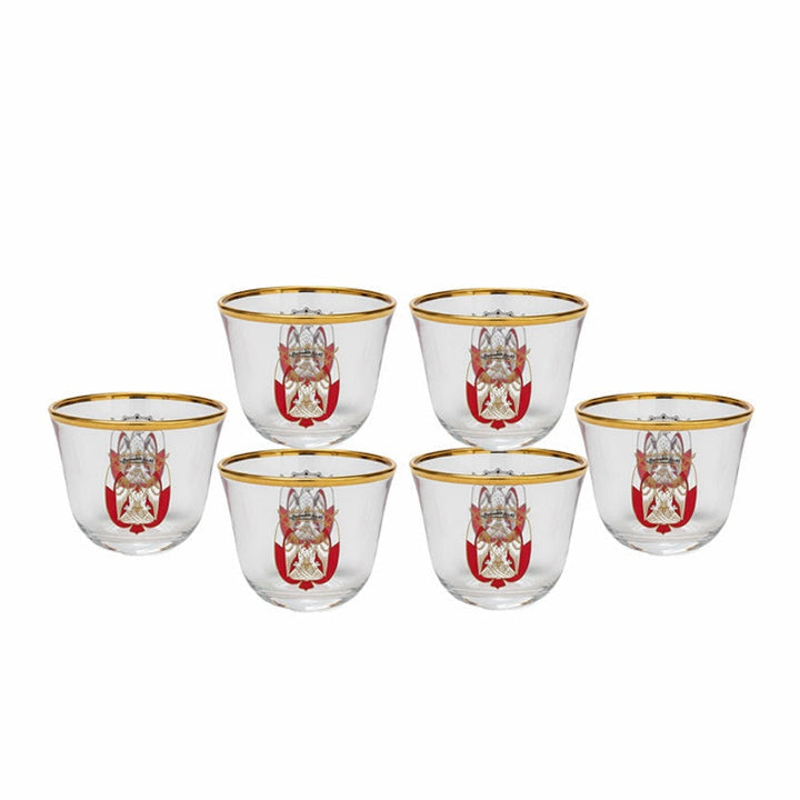 Set of six glass tumblers with gold rims and red and white designs on a white background