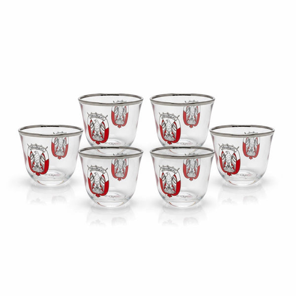 Set of six clear glasses with red and white designs on a white background