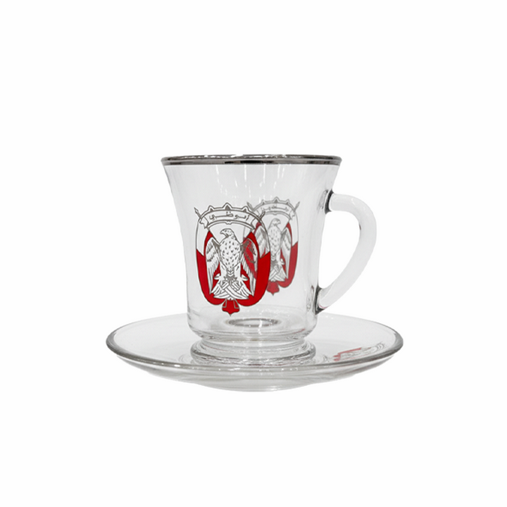 Clear glass cup with red and white emblem on a white background