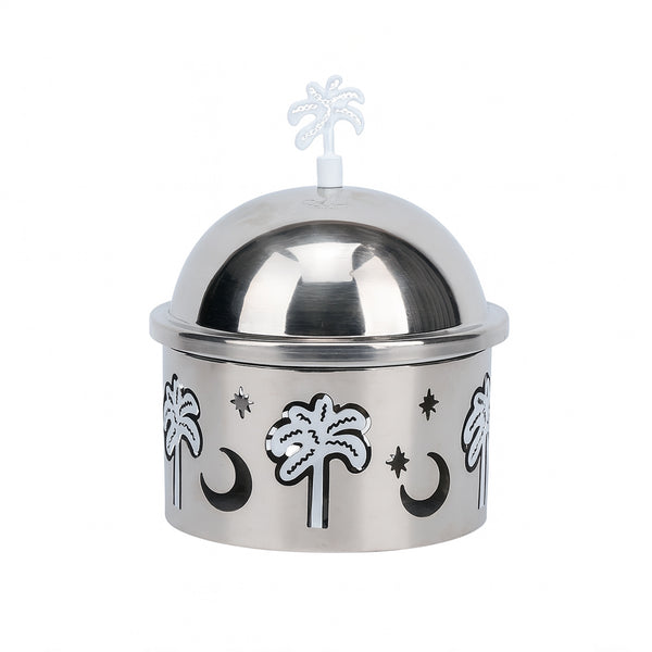 Silver dome container with palm tree and moon designs on a white background