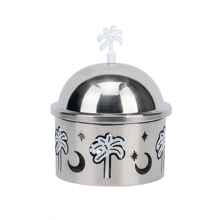 Silver dome container with palm tree and moon designs on a white background