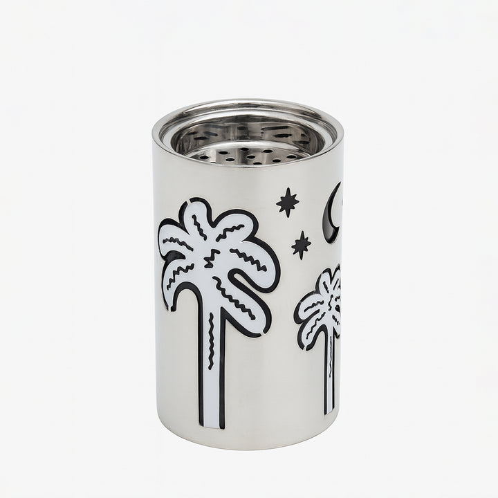 Silver cylindrical container with black palm tree and moon designs on a white background