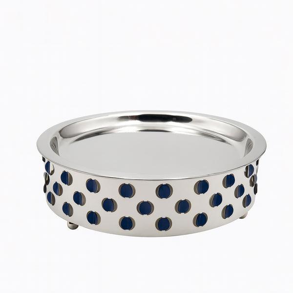Silver bowl with blue circular patterns on a white background