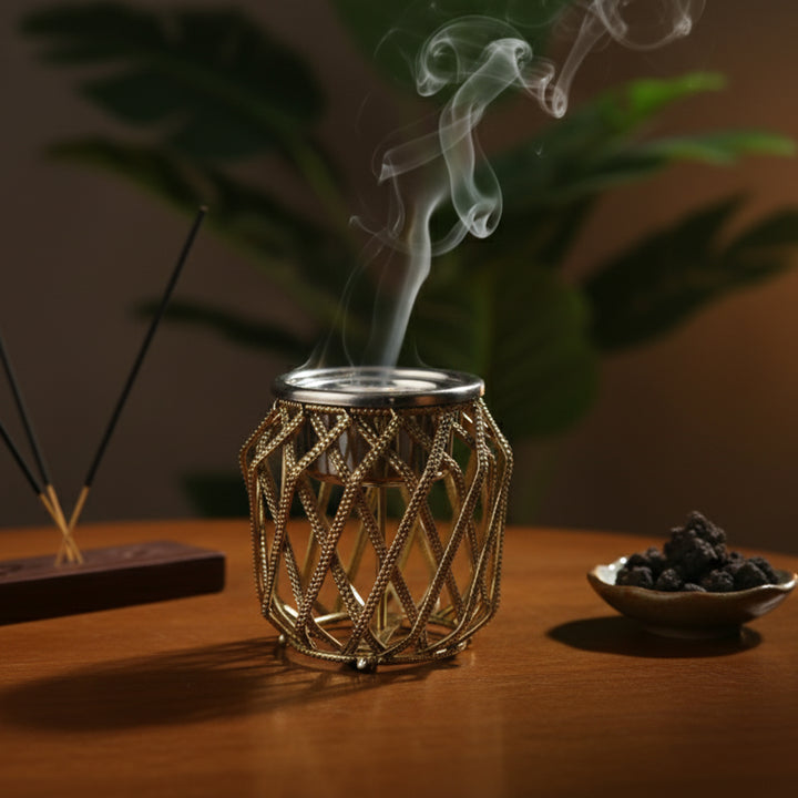 Decorative incense burner with smoking incense on a wooden surface