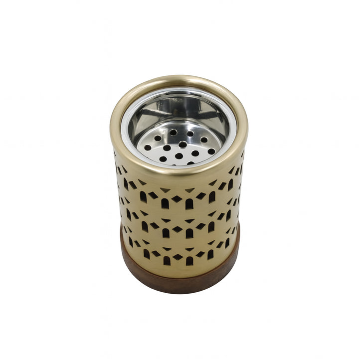Gold-colored metal ashtray with a perforated design on a white background
