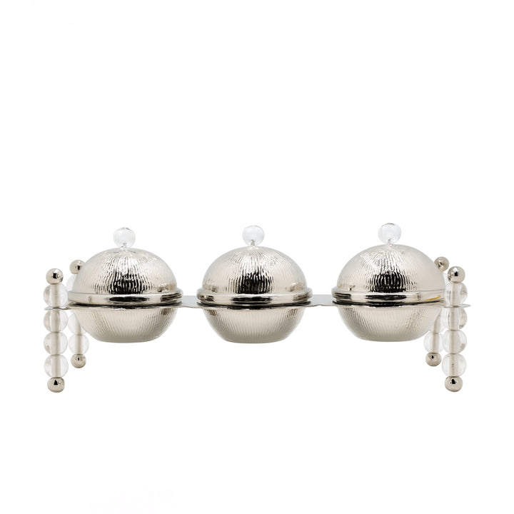 Decorative wall piece with three spherical silver elements on a white background