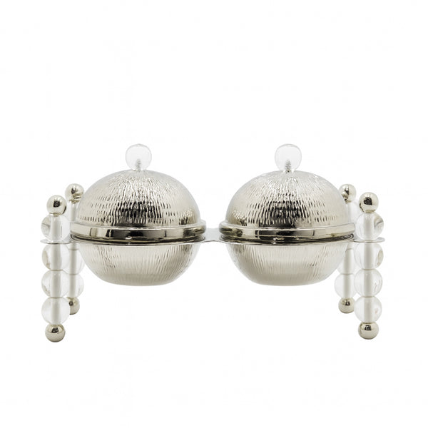 Silver tea infuser with two round compartments on a white background