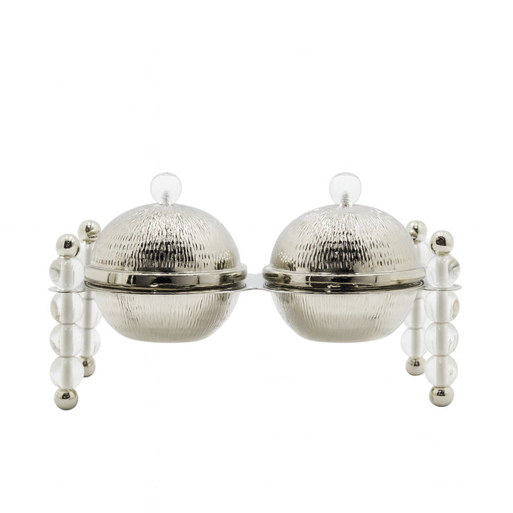 Silver tea infuser with two round compartments on a white background