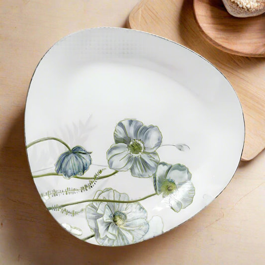 Elegant ceramic plate with a smooth finish, featuring a modern design. Perfect for serving meals or as a decorative piece for the kitchen or dining room. Available at Siddiq Gifts.