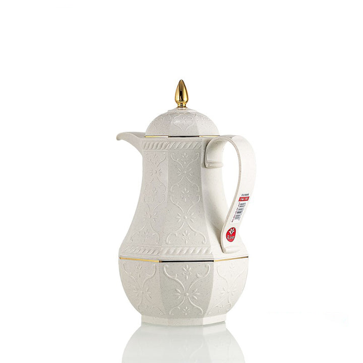 White ceramic coffee pot with gold accents on a white background