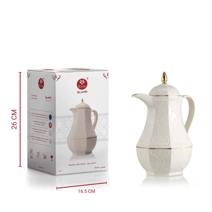 White ceramic teapot with gold accents next to its packaging box on a white background