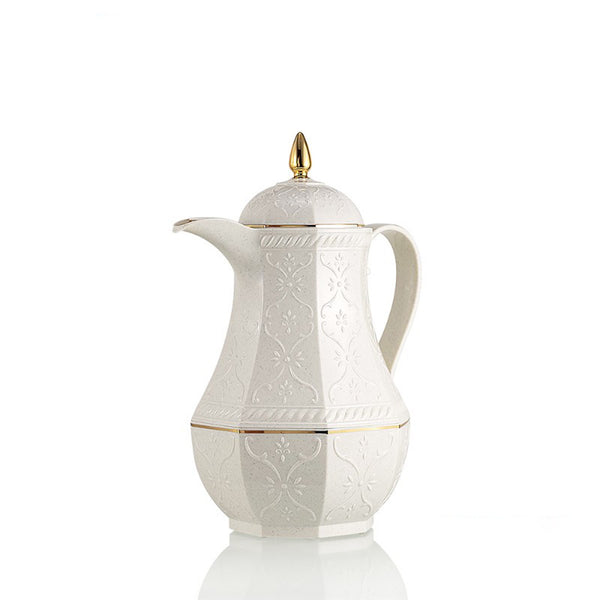 White ceramic coffee pot with gold accents on a white background