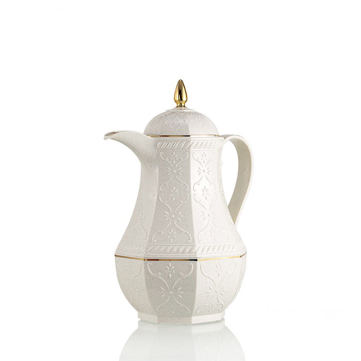 White ceramic coffee pot with gold accents on a white background