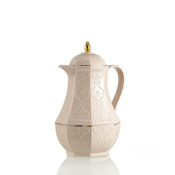 Decorative cream-colored coffee pot with gold accents on a white background